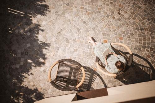 a woman is laying on a floor with a basket at Milla Apartments in Bressanone