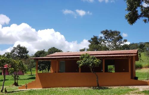 a small house in the middle of a field at Pousada Águas da Canastra in Vargem Bonita