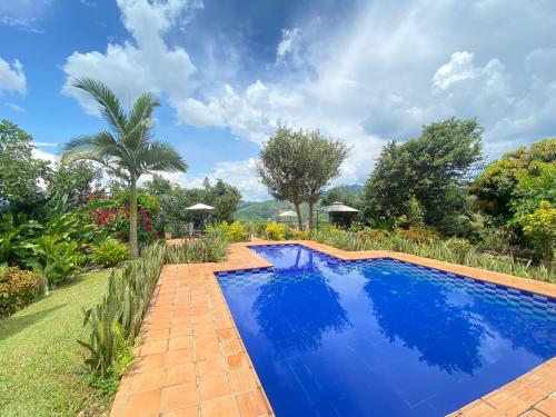 an image of a swimming pool in a garden at Tierra Mágica eje cafetero in Manizales