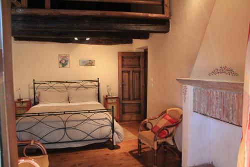 a bedroom with a bed and a fireplace at La Collina dei Passeri in Pocapaglia