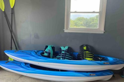 a blue kayak sitting in a room with a window at Mountain View Getaway - Stunning Views and Privacy in Shenandoah