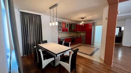 a kitchen and dining room with a table and chairs at Prishtina rental house in Prishtinë