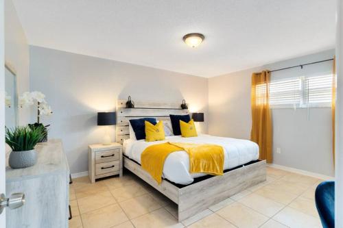 a bedroom with a large bed with yellow pillows at Ocean 16 - Pier View in Indian Harbour Beach