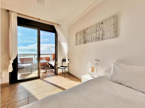 a bedroom with a bed and a view of the ocean at Sunny Home La Tejita in Granadilla de Abona