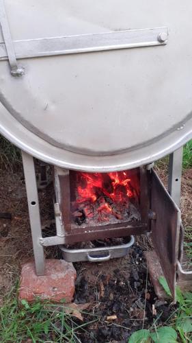 a stove with a fire under a table at Vareš in Vareš
