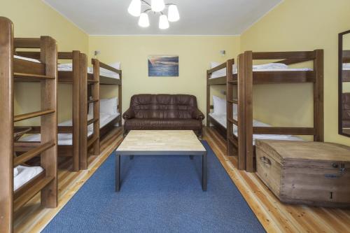 a room with bunk beds and a couch and a table at Castle-Wall-Inn in Mikulov