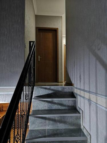 a staircase in a building with a door at UP Holiday Home in Stepantsminda