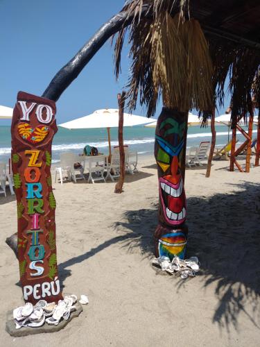 two totem poles in the sand on the beach at La palmera zorritos in Tumbes
