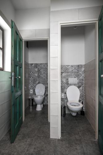 a bathroom with two toilets and two sinks in it at Castle-Wall-Inn in Mikulov