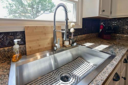 a stainless steel sink in a kitchen with a window at Large, private home mins to Silver Dollar City! in Branson West