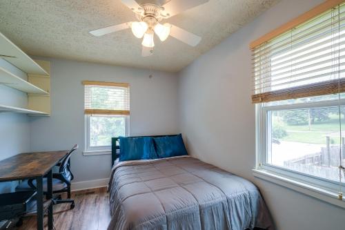 a bedroom with a bed and a table and windows at Blacksburg Vacation Rental Near Virginia Tech! in Blacksburg