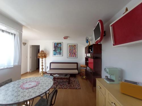 a living room with a table and a couch at Romoa - Gerês & Cabreira in Vieira do Minho