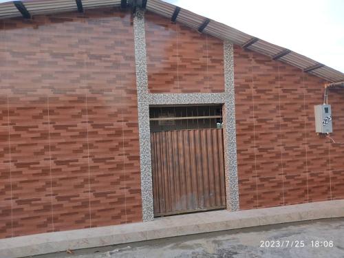 a brick wall with a gate on the side of a building at EL DORADO POUSADA in Barcelos