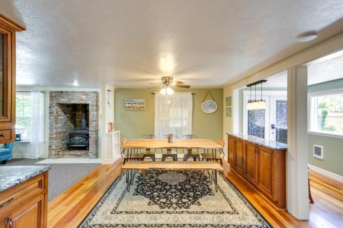 a living room with a table and a fireplace at Coastal Lincoln City Home with Spacious Deck! in Lincoln City