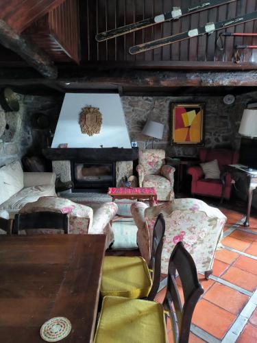 a living room with a table and chairs and a piano at CASA DO ARCO - BARCELOS in Barcelos