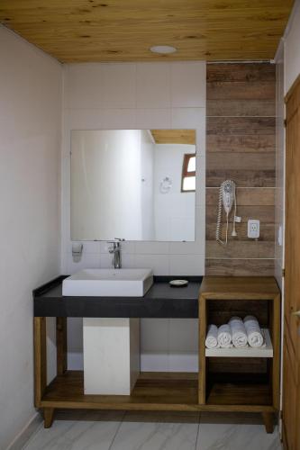 a bathroom with a sink and a mirror at Complejo Paranay in Puerto Paranay