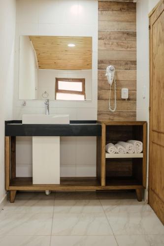 a bathroom with a sink and a counter with towels at Complejo Paranay in Puerto Paranay