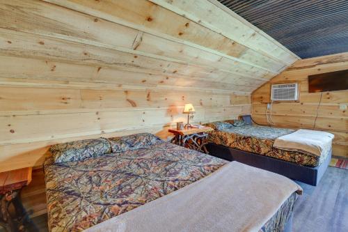 a bedroom with two beds in a log cabin at Cozy Huntsville Escape with Brimstone Trail Access! in Huntsville