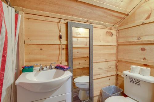 a bathroom with a white sink and a toilet at Cozy Huntsville Escape with Brimstone Trail Access! in Huntsville