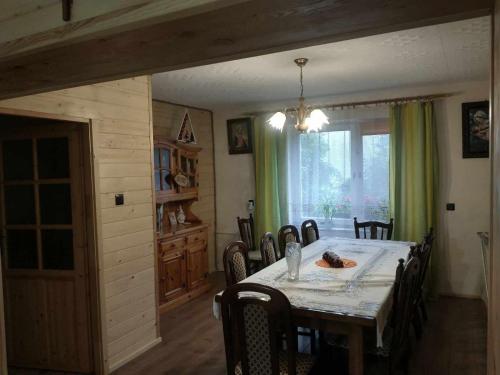 a dining room with a table and chairs at Noclegi Żurawin in Lutowiska