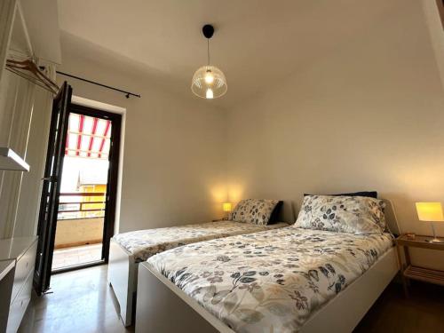 a bedroom with a bed in a room with a window at Appartamento Panoramico su Lago in Trevignano Romano