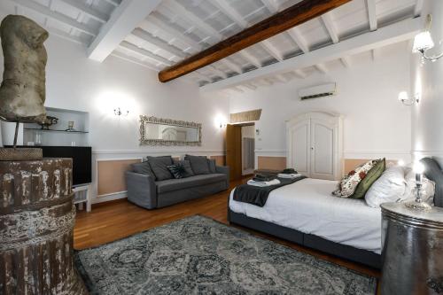 a living room with a bed and a couch at Castel Sant'Angelo Apartments - Exclusive & Luxury in Rome