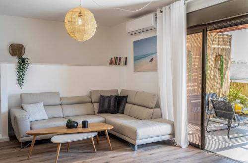 a living room with a couch and a table at Hakochav in Eilat