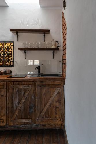 a kitchen with a wooden counter with a sink at Gotyk na dotyk z tarasem na dachu in Toruń