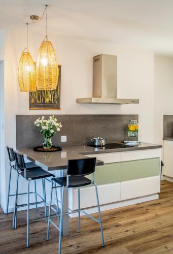 a kitchen with a table with chairs and a counter at Hakochav in Eilat