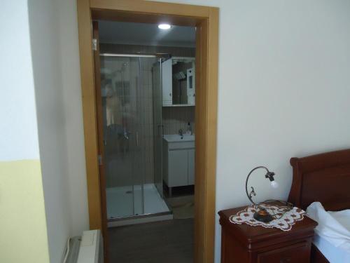 La salle de bains est pourvue d'une douche, de toilettes et d'un lavabo. dans l'établissement Alojamento Poço do Barro, à Lodões