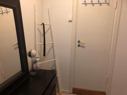 a bathroom with a door next to a mirror at Grefsen/Central Oslo in Oslo