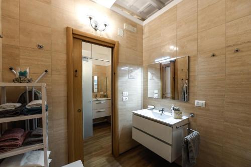 a bathroom with a sink and a mirror at Castel Sant'Angelo Apartments - Exclusive & Luxury in Rome