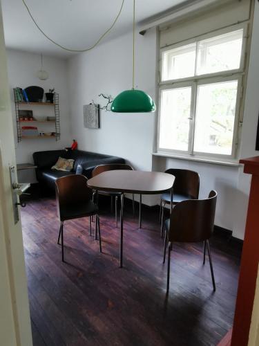 a living room with a table and chairs and a couch at Gundis Gästezimmer in Bamberg