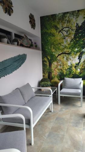 a room with two beds and a painting on the wall at Boutique Hotel Ferrara in Ferrara