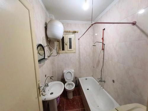 a bathroom with a sink and a toilet and a bath tub at Rental home ismailia in Ismailia