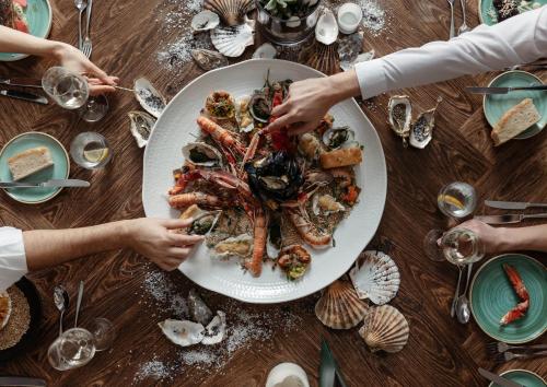a table with a plate of seafood on it at Kimpton Blythswood Square Hotel & Spa by IHG in Glasgow