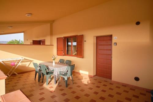 a dining room with a table and chairs and a door at Residence Costa Tirrena in Torrenova