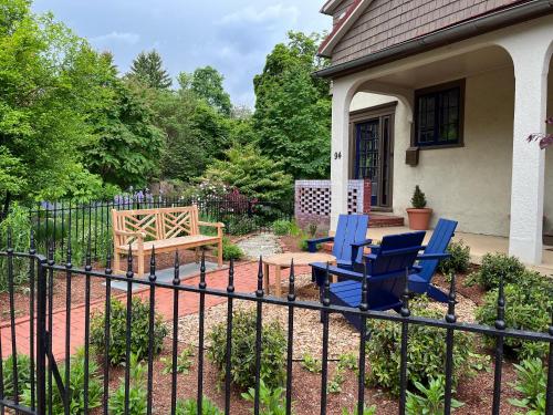 a fence with two chairs and a bench in a yard at Spectacular Location Two Bedroom State Circle Apartment in Annapolis