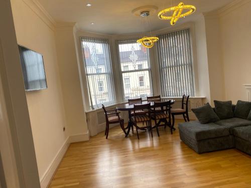 a living room with a table and chairs and a couch at Designer Apartment APT6 in Wolverhampton