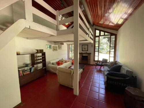 a living room with a couch and a loft at Casa linda no sítio in Duque de Caxias