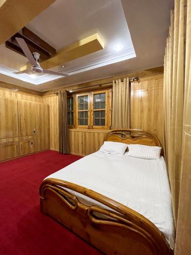 a bedroom with a large bed in a room at Paradiso Lodge Skardu in Skardu