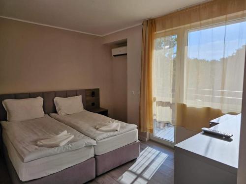 Posteľ alebo postele v izbe v ubytovaní Lotos Apartments