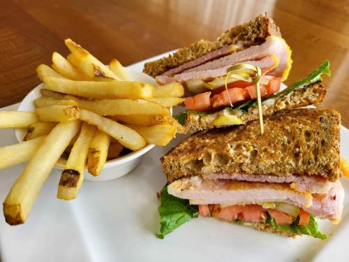 a sandwich and french fries on a white plate at Sheraton Parkway Toronto North Hotel & Suites in Richmond Hill