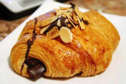 a pastry with chocolate and nuts on a white plate at Jiwar Almasi Hotel in Jeddah