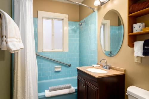 a bathroom with a sink and a shower with a mirror at Prescott Pines Inn in Prescott