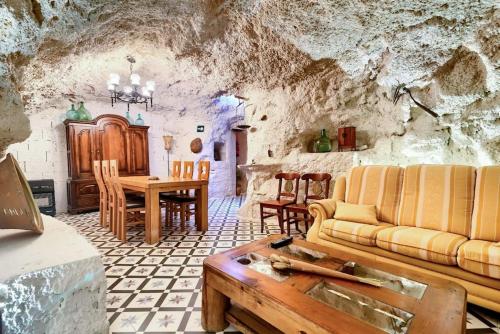 a living room with a couch and a table at Cueva con jacuzzi a 20 minutos de Valencia in Benaguacil