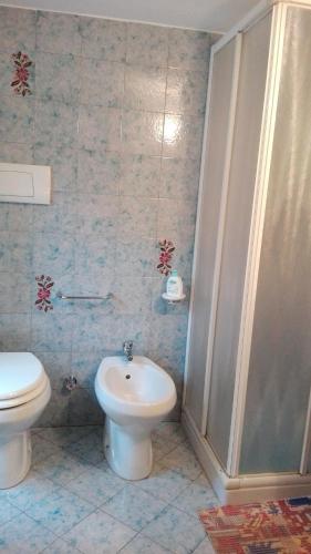 a bathroom with a toilet and a sink and a shower at B&B ERMINIA in Laino Borgo