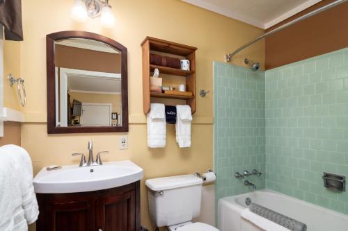 a bathroom with a sink and a toilet and a mirror at Prescott Pines Inn in Prescott