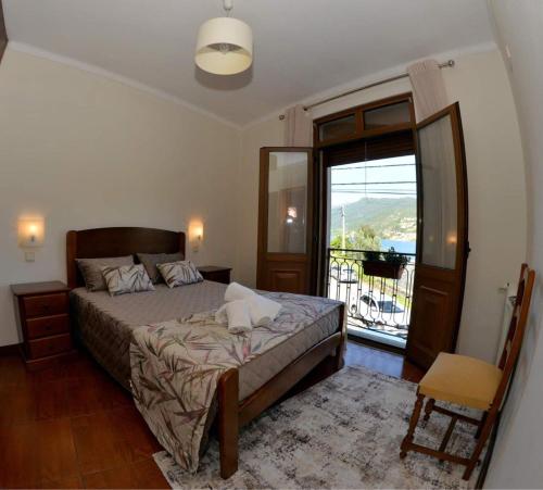 a bedroom with a bed and a sliding glass door at Menina do Rio in Rio Caldo