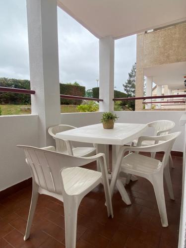 a white table and chairs on a balcony at El mirador de mogro in Mogro